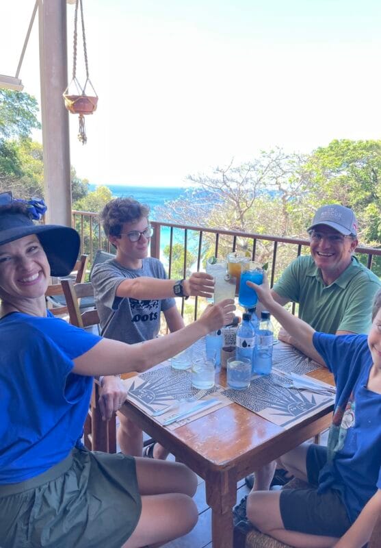 Cheers at a delicious restaurant overlooking the beach