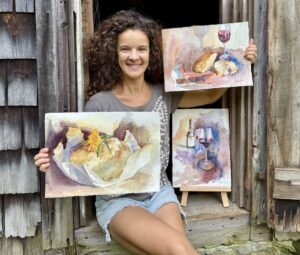 Jonalyn holding her series "Satisfaction"