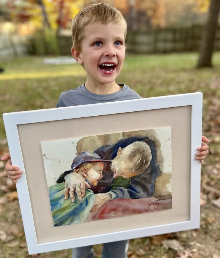 Young boy holding his commissioned painting of him with his grandpa