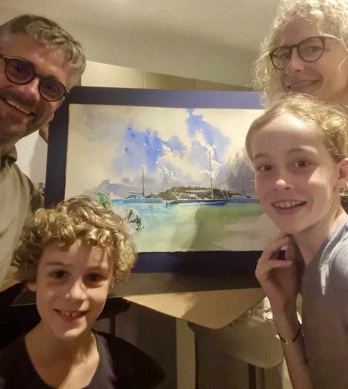 Family with their commissioned painting of their boat at sea